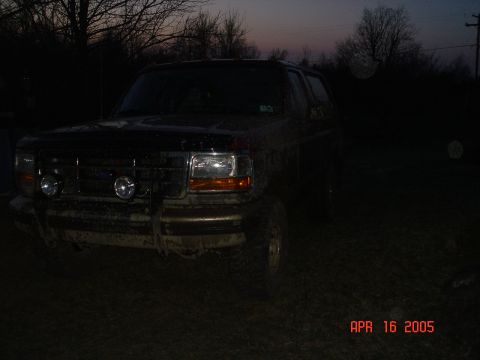 1995 Ford Bronco - This 1995 Ford Bronco is seen in a muddy, outdoor setting at dusk.