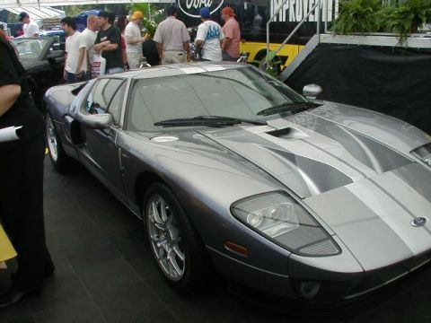 1993 Ford Probe - A silver Ford GT with racing stripes is displayed at an event.