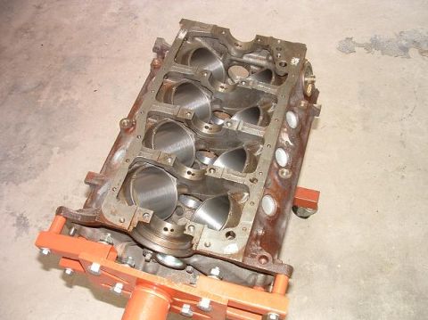 1985 Ford LTD Crown Victoria - This is a bare engine block, likely for a rebuild or custom build, resting on an engine stand.