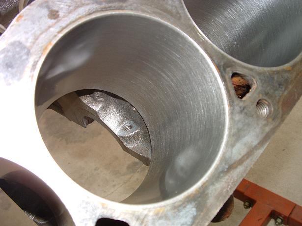 Close-up of a vehicle engine's cylinder bores, showing the machined surfaces inside