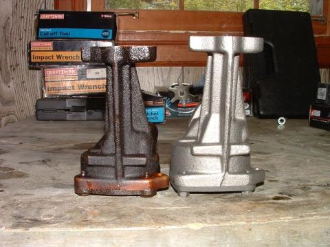 1985 Ford LTD Crown Victoria - Two engine components are displayed, one showing signs of use and the other appearing newly refurbished.