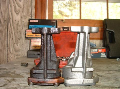 1985 Ford LTD Crown Victoria - Comparison of a used engine mount next to a newly cleaned or replaced one, with tools in the background.
