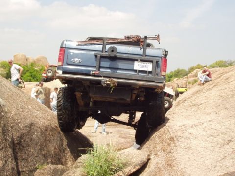 1986 Ford Bronco - This modified Ford Bronco navigates a rocky trail, its off-road capabilities.
