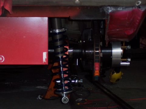 1971 Ford Mustang - Close-up view of a vehicle's rear suspension and brake assembly, a coilover shock and disc brake system.