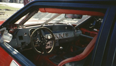 1993 Ford Mustang - Interior view of a race car, a roll cage and custom dashboard with numerous gauges.
