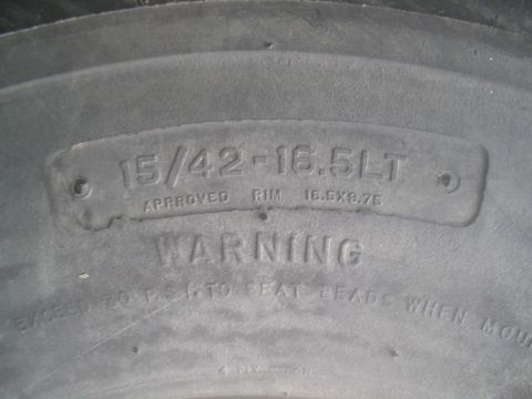 1983 Ford F-250 - Close-up of a tire sidewall displaying size and rim information, along with a pressure warning.