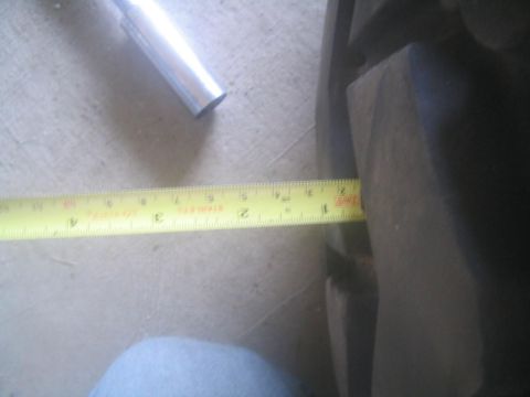 1983 Ford F-250 - A yellow tape measure is used to measure the width of a dark-colored tire.