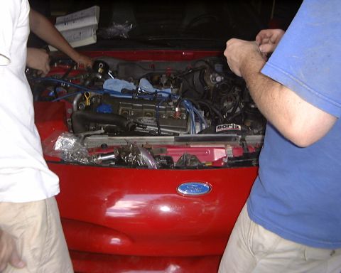1994 Ford Probe - Working on the engine of a 1994 Ford Probe, with the hood open and parts visible.