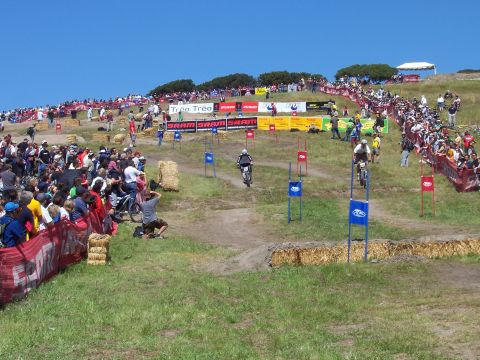 1998 Ford Ranger - Spectators watch a downhill mountain bike race event with multiple riders on the course.
