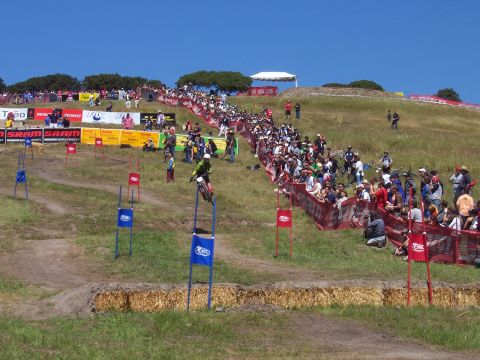 1998 Ford Ranger - Spectators line the course of a motocross event under a clear blue sky.
