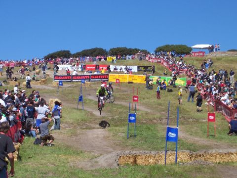 1998 Ford Ranger - Spectators gather to watch a mountain biker compete in a race event on a sunny day.