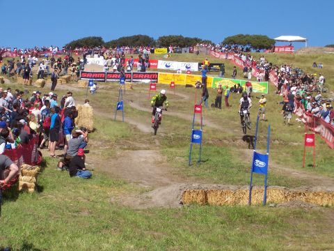 1998 Ford Ranger - Downhill mountain bike race with spectators lining the course on a sunny day.
