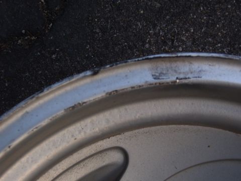 1993 Ford Bronco - A close-up view of a silver wheel rim shows signs of wear and tear.