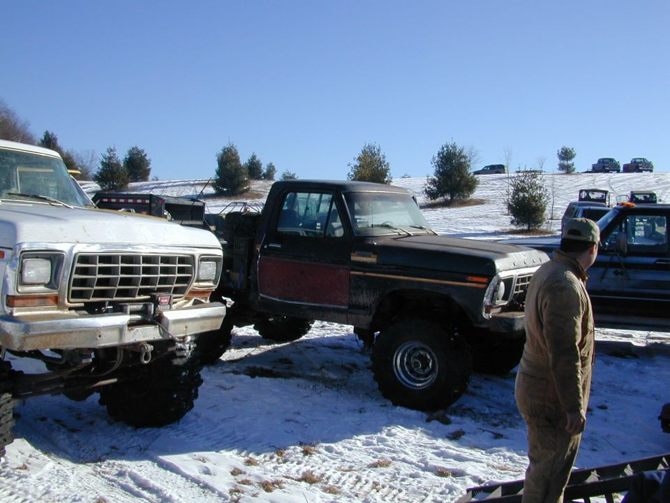 1979 Ford F-150 pickup truck parked next to another truck in a snowy field
