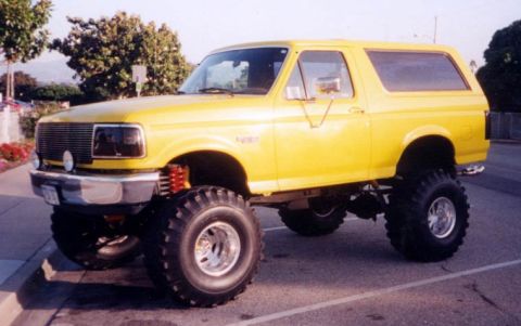 1986 Ford Bronco - This modified Ford Bronco features a significant lift kit and oversized off-road tires.