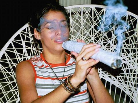 1986 Ford Bronco - A woman is shown smoking a very large joint, with smoke billowing around her face.