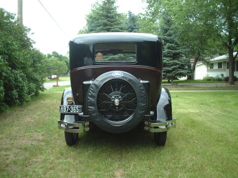 1929 Ford Model A - Rear view of a 1929 Ford Model A sedan showing its spare tire and license plate.