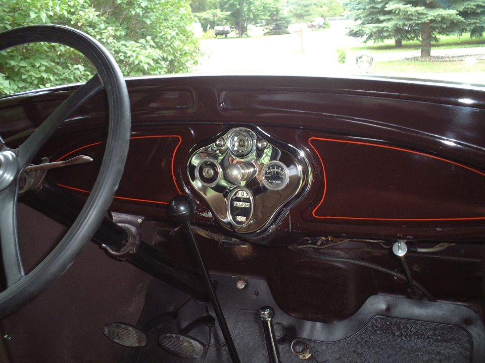 Ford Model A dashboard with oval instrument cluster, ammeter and odometer reading 3049