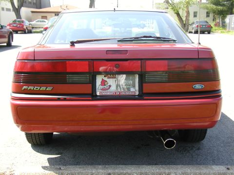1991 Ford Probe - The rear of a red 1991 Ford Probe is shown, its taillights and a custom license plate frame.