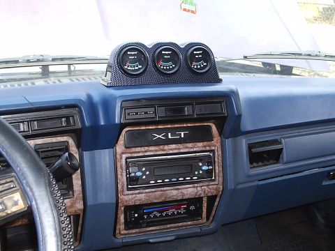 1985 Ford Bronco - Dashboard of a 1985 Ford Bronco XLT trim and a trio of aftermarket gauges mounted above the radio.