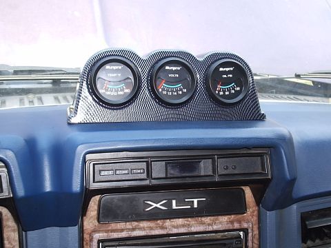1985 Ford Bronco - Aftermarket Sunpro gauges installed on a vehicle's dashboard.