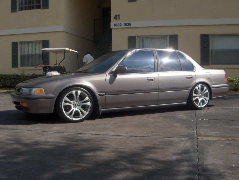 Tan Honda Accord sedan, lowered on chrome wheels, side/front view in apartment lot