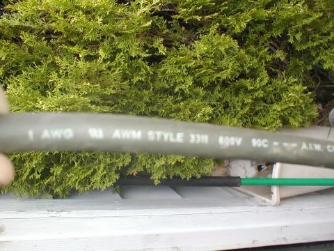1979 Ford Bronco - Close-up of electrical wire with specifications printed on its casing.