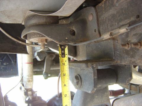 1993 Ford Bronco - Measuring suspension component clearance with a tape measure.