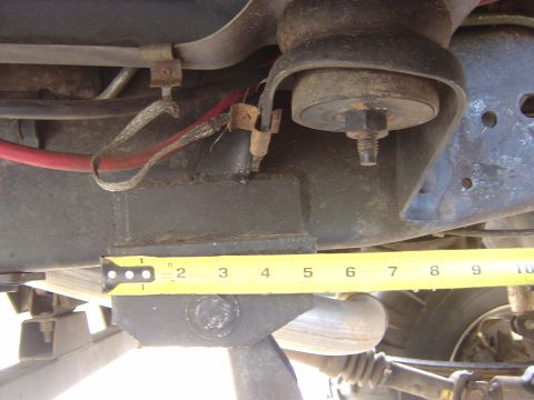 1993 Ford Bronco - Close-up view of vehicle undercarriage components, with a tape measure indicating a specific dimension.