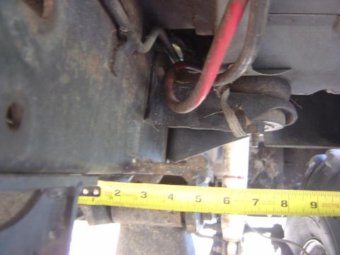 1993 Ford Bronco - A close-up view of a vehicle's undercarriage, with a measuring tape indicating a length of about 4 inches.