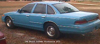 1994 Ford Crown Victoria - This light blue 1994 Ford Crown Victoria P71 sedan is shown from the side.