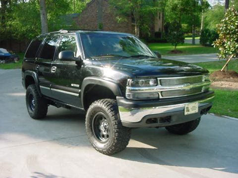 2000 Chevrolet Tahoe - Lifted 2000 Chevrolet Tahoe with chrome grille and aftermarket wheels.
