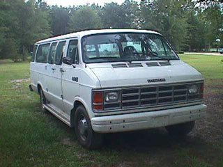 1994 Ford Crown Victoria - This is a white Dodge van, model year is not discernible from the image.