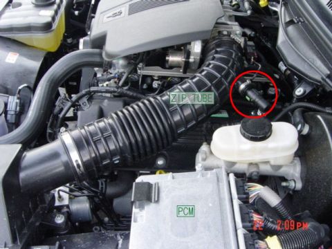 2000 Ford Crown Victoria - Close-up view of an engine bay, highlighting the air intake system and PCM module.