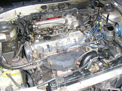1990 Ford Probe - Close-up view of a car's engine bay, showing the engine and associated components.
