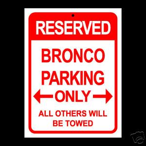 1979 Ford Bronco - A sign indicates that parking is reserved exclusively for Broncos, with a warning that all others will be towed.