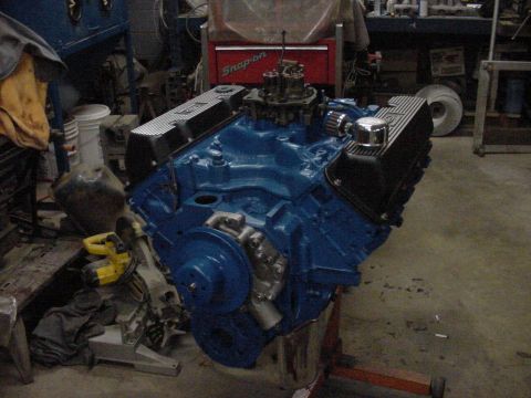 1969 Ford Bronco - Blue V8 engine on an engine stand, likely undergoing rebuild or modification.