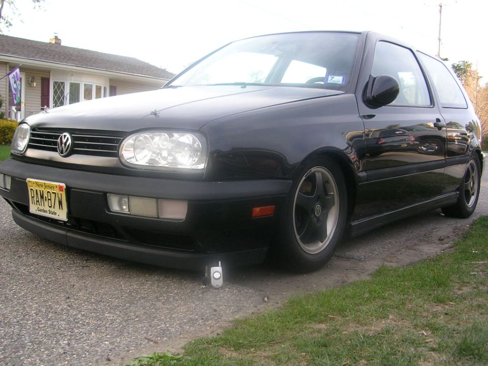 Black Volkswagen Golf Mk3 with New Jersey plates, parked on a gravel driveway