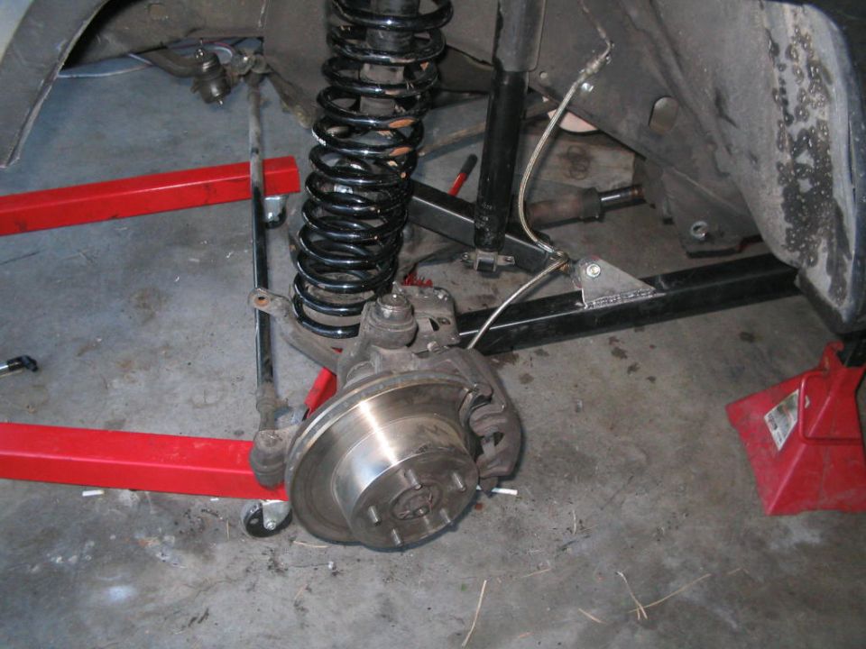 Front suspension rebuild with bare brake rotor, coil spring and new black control arms