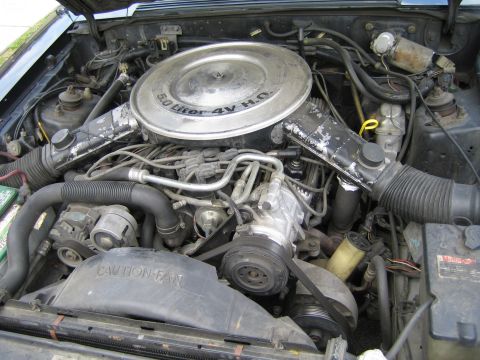 1985 Ford Mustang - The engine bay of a Ford vehicle, a 5.0 Liter 4V HO engine and a 'CAUTION FAN' shroud.