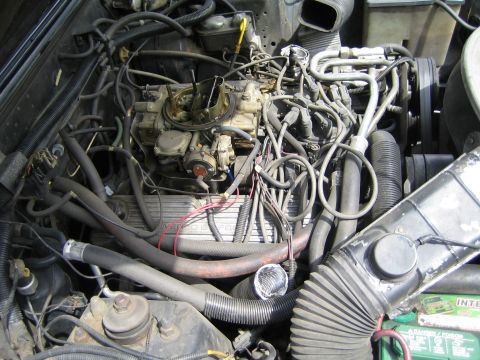 1985 Ford Mustang - Close-up view of a vehicle's engine compartment, showing various components and wiring.