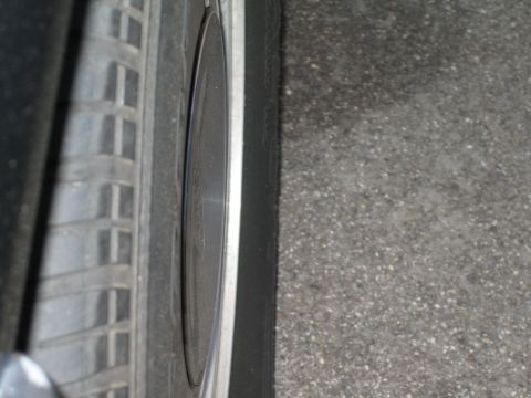 1985 Ford Mustang - Side view of a car's wheel and tire, showing tread pattern and rim detail.