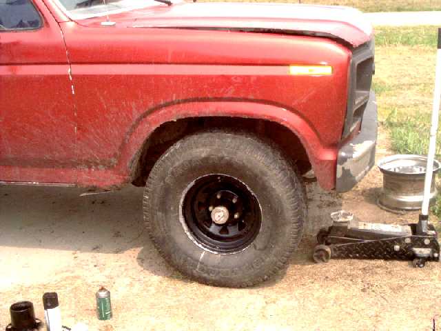 33x12.50R15 WideTrack Baja AT tires on 15x9" black spoke rims