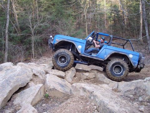 1974 Ford Bronco - This modified 1974 Ford Bronco is navigating a challenging rocky terrain during an off-road adventure.
