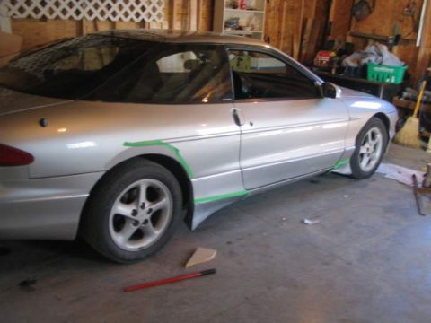 1993 Ford Probe - A silver 1993 Ford Probe coupe is shown in a garage with green tape outlining modifications to its side skirts.