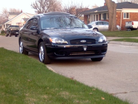 2004 Ford Taurus - new mustang mach 1 chin splitter and 17in paradyme f220's chrome rims.