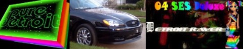 2004 Ford Taurus - Front 3/4 view of a black 2004 Ford Taurus, chrome wheels and a prominent grille.