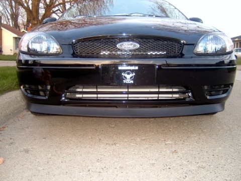 2004 Ford Taurus - Front view of a black 2004 Ford Taurus, showing the grille, headlights, and license plate area.