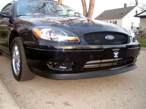 2004 Ford Taurus - Front view of a black 2004 Ford Taurus, showing the grille and headlights.