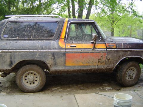 1979 Ford Bronco - This 1979 Ford Bronco is heavily covered in mud, obscuring much of its original paint and details.